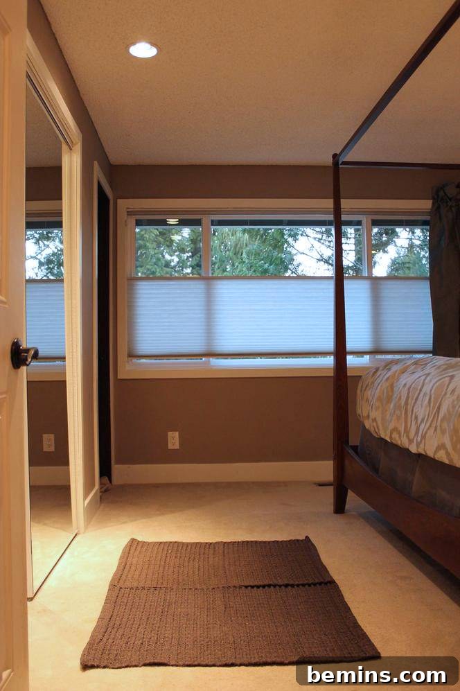 Elegant Newlywed Bedroom Sanctuary Unveiled 5 Close-up of newly painted gray wall with pristine white trim