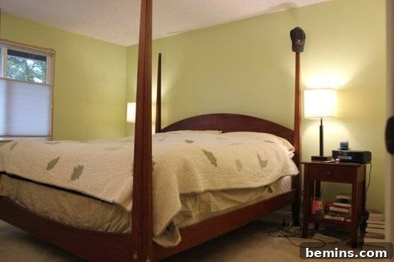 Elegant Newlywed Bedroom Sanctuary Unveiled 8 Before shot of the bed with an old quilt and exposed box spring