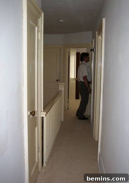 A plain white hallway lacking character and visual interest
