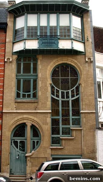 The Unforgettable Entrance 3 A thin multistory brick building. Art Nouveau building facade in Brussels.
