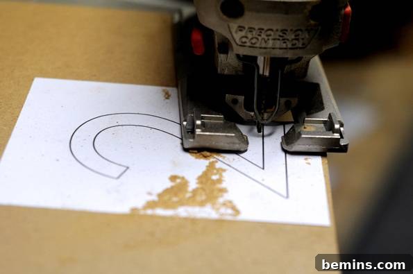Using a jigsaw to cut out the modern house number template