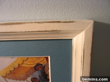 Vaseline Wood Distressing: A Simple DIY Guide 2 Distressed, cream colored frame hanging on a wall.