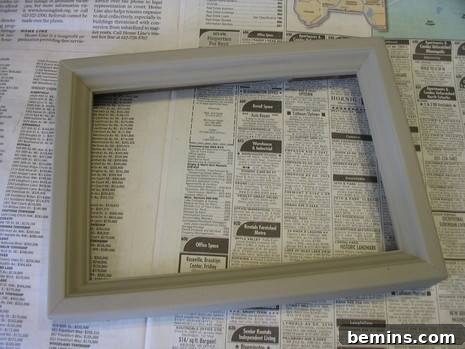 Vaseline Wood Distressing: A Simple DIY Guide 3 A freshly painted grey picture frame rests on some newspaper.