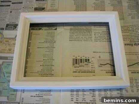 Vaseline Wood Distressing: A Simple DIY Guide 5 White wooden picture frame on top of newspaper.