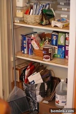 A 3 tier closet storage space with many items on each shelf before organization.
