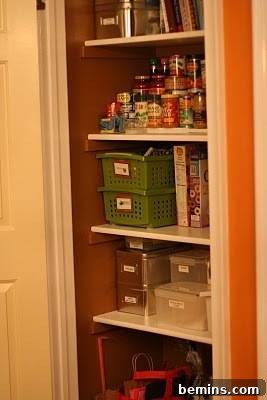 Pantry items arranged in racks with clear containers and labels after makeover.
