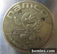A coin with four drilled holes, cleaned and ready for the next step in the DIY button-making process.