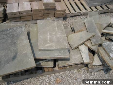 Rectangular ceramic tiles next to bricks stacked on wood pallet.