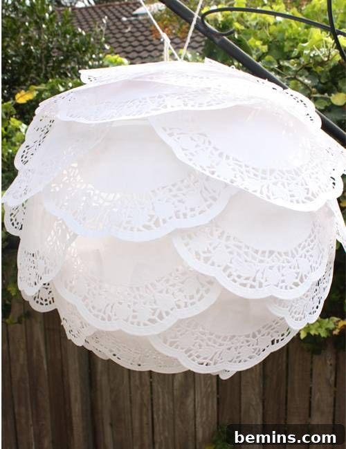 A stunning paper lantern decorated with delicate paper doilies, showcasing a vintage and elegant design.
