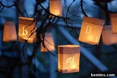 A lighted pennant garland made of colorful paper pendants, adding a festive and playful touch to outdoor lighting.