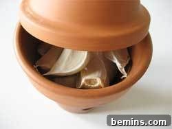 Garlic cloves in terra cotta container for storage.