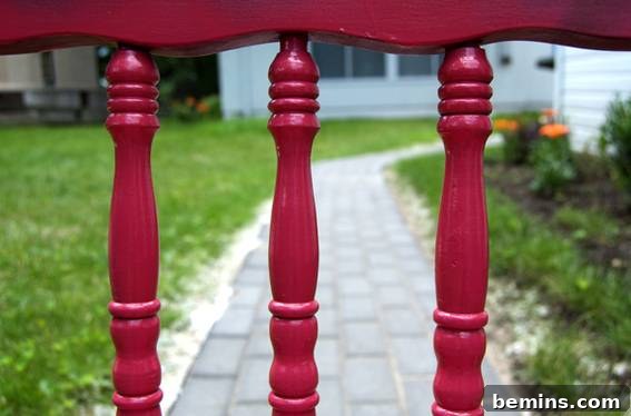 The rocking chair after its first application of pink paint on the spindles, showing initial progress