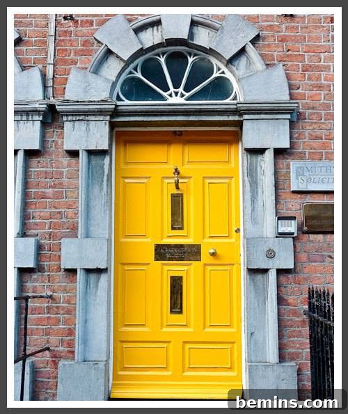 Yellow color front door of a house, showcasing a cheerful and welcoming entrance.