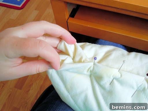 Turning Old Pillows into Dreamy Comfort: A DIY Transformation 11 Close-up of the pinned corners of a pillow, showing how the fabric is folded and secured.