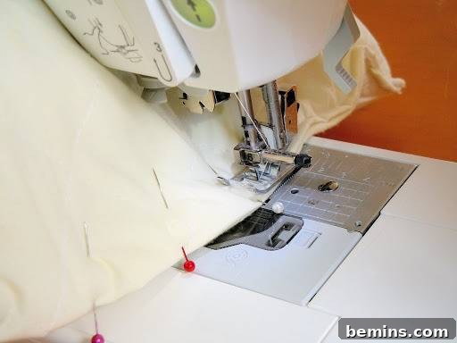 Turning Old Pillows into Dreamy Comfort: A DIY Transformation 13 Image of fabric being sewn together using a sewing machine, creating a durable seam.