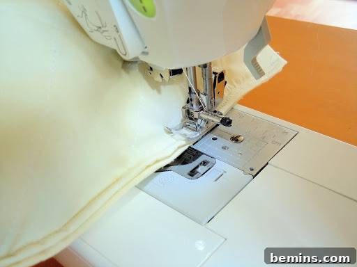 Turning Old Pillows into Dreamy Comfort: A DIY Transformation 14 Reinforcing stitches being added to a pillow case for extra strength and durability.
