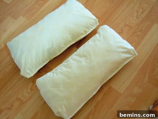Turning Old Pillows into Dreamy Comfort: A DIY Transformation 15 Two finished white pillow forms sitting on a wooden floor, ready to be covered with custom-made slipcovers.