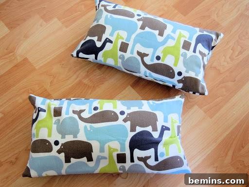 Turning Old Pillows into Dreamy Comfort: A DIY Transformation 16 Two throw pillows covered with vibrant animal-printed fabric, showcasing the finished result of the DIY project.