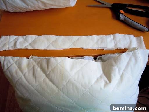 Turning Old Pillows into Dreamy Comfort: A DIY Transformation 8 Close-up of a pillow being worked on, with the edges being prepared for sewing.