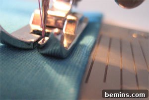 Sewing Machine Basics: A Guy's (and Gal's) Guide to Stitches & Seams Crafting Confidence: Mastering Stitches and Seams for Everyone 11 A close-up of a sewing machine threading fabric with a straight guide