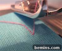 Sewing Machine Basics: A Guy's (and Gal's) Guide to Stitches & Seams Crafting Confidence: Mastering Stitches and Seams for Everyone 9 Sewing machine stitching a piece of cloth