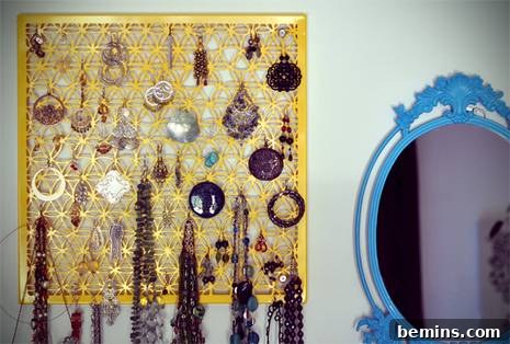 A secondhand table creatively transformed into a jewelry organizer with hooks and designated spaces for accessories.