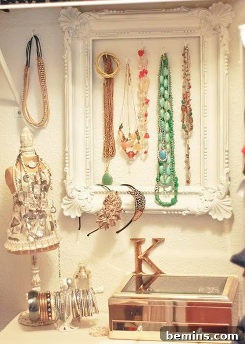 Old frame + hooks approach. An old picture frame with hooks attached to hold jewelry.