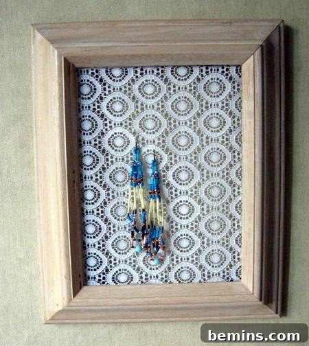 Old frame + lace option. An old picture frame with lace stretched across, used to hang earrings.