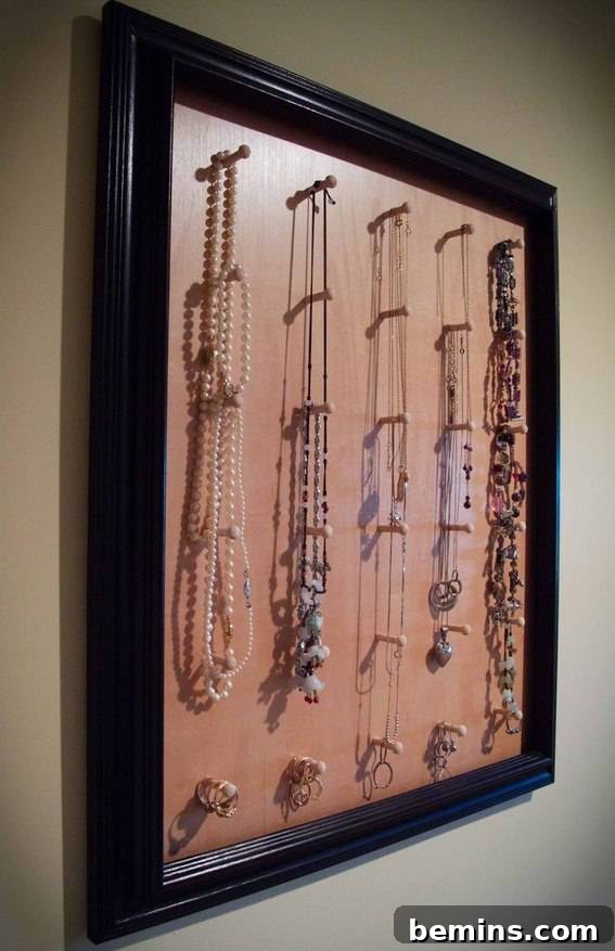 The jewelry pegboard. A pegboard with pegs and hooks used to organize and display jewelry.