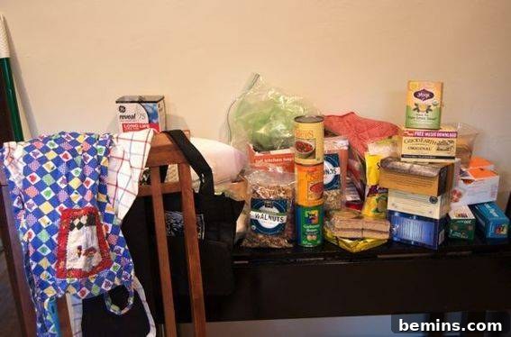 Kitchen counter completely covered in items removed from the cupboards and pantry, awaiting organization.