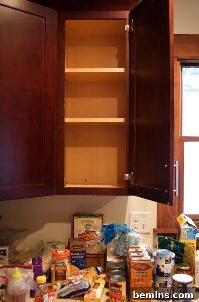 A storage wardrobe temporarily holding kitchen items during the organization process.