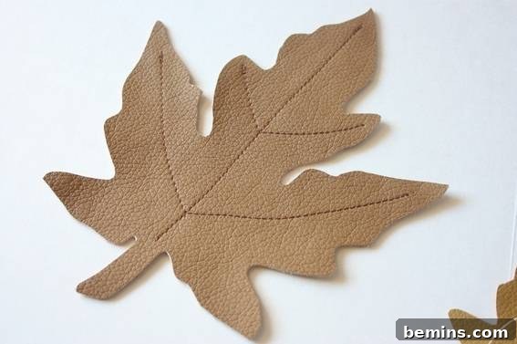 Pile of veined faux leather leaves. Ready to be assembled into a beautiful table runner.