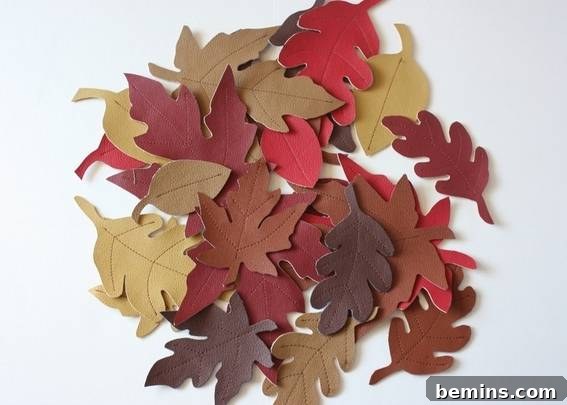 Laying out leaves to create the base of the table runner. Planning the design before sewing.