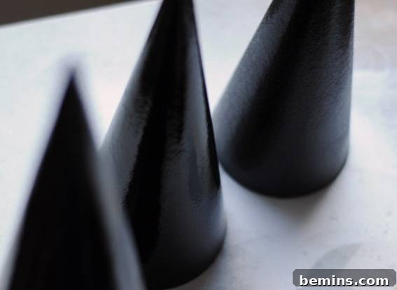 Spray Painting Paper Mache Cones Black