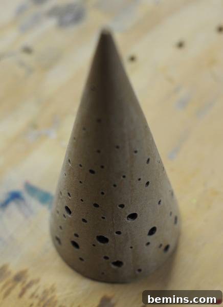 Crafting Contemporary Perforated Christmas Trees 5 Using a rotary tool to smooth the edges of the holes.