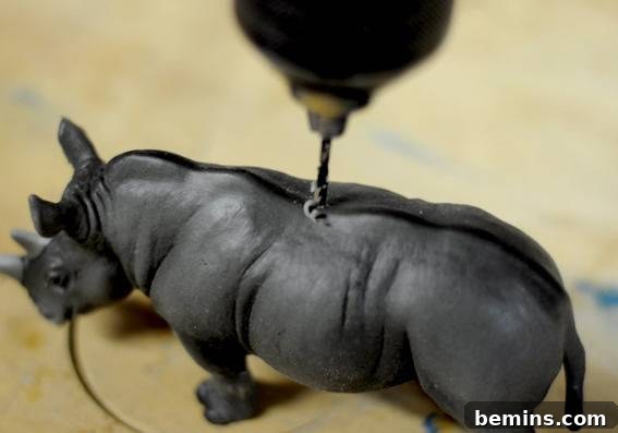 How to Craft Dazzling Animal Ornaments for Christmas 4 Drilling a pilot hole in a plastic animal