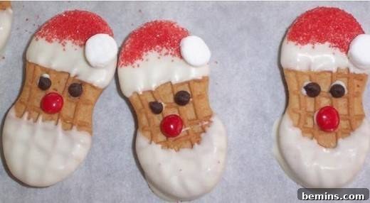 Peanut butter cookies with Santa faces in a row.
