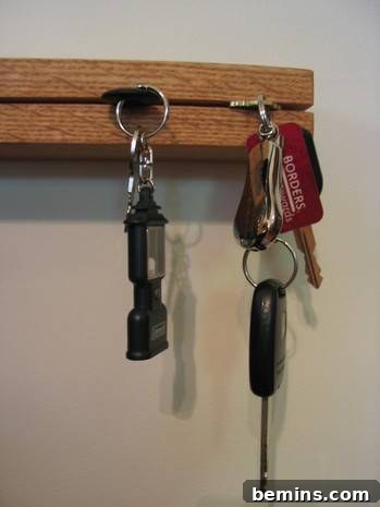 Keys are placed in a key rack.  The finished DIY key rack mounted and holding keys.
