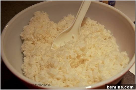 A bowl of rice with a spoon.