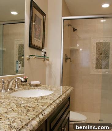 The Unexpected Reasons People Are Ditching Granite Countertops 3 Bathroom remodel featuring granite countertop, granite shower tiles, and cherry wood cabinets