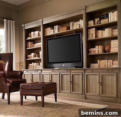 A wooden library with books and a TV in the center, Restoration Hardware, demonstrating how to blend entertainment with a classic design.