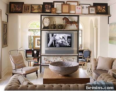 A living room with framed pictures above a television, showcasing how to integrate a TV into a stylish and cohesive design.