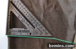 Cutting the pants leg to create the initial shorts shape.