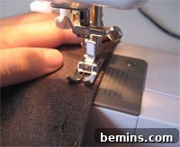 Sewing the first hem on the shorts leg.