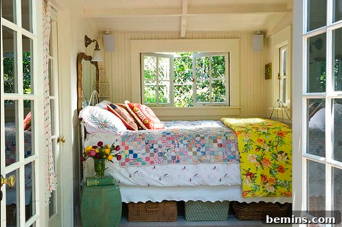 Cozy cottage-style small bedroom with inviting bed and windows