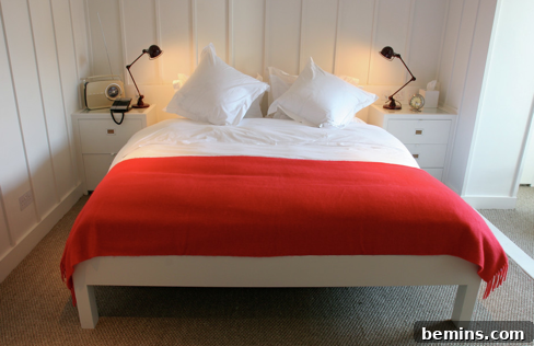 Small hotel bedroom with built-in side tables