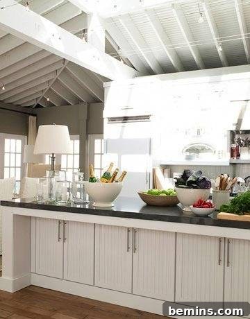 White kitchen with a single lamp adding a touch of informal elegance