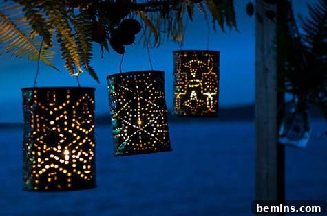 Three coffee can lanterns hanging from a tree