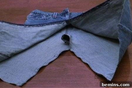 From Denim to Dream Skirt: A DIY Transformation 9 Denim jeans that have been cut short and sewn to turn into a skirt, showcasing the preliminary shape.