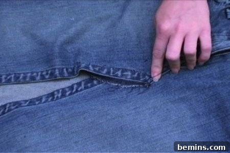 From Denim to Dream Skirt: A DIY Transformation 12 Working on and altering a blue jeans by pinning the front pieces together.